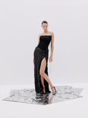 A Black Strapless Gown with a High Slit and Textured Skirt